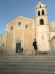 Joy standing in front of church building