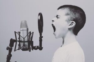 boy shouting into microphone