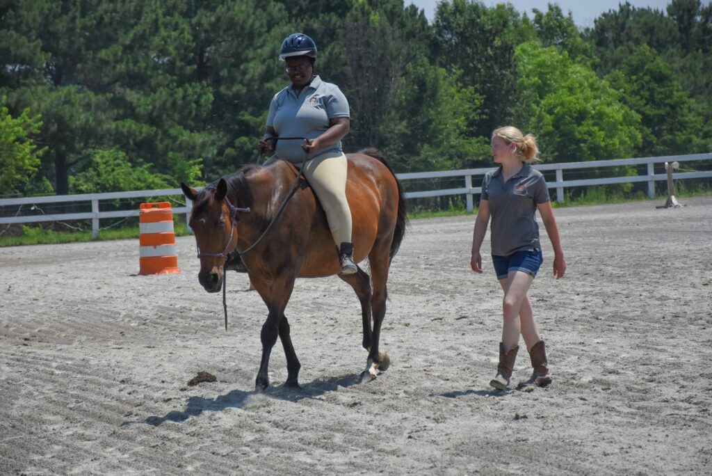 Ciara riding Horse while Leanne walks beside her