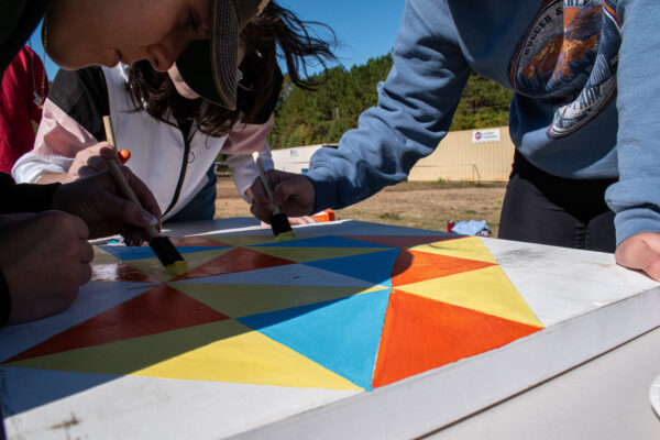 Volunteers quilt painting activity during CORRAL Fall on the Farm!